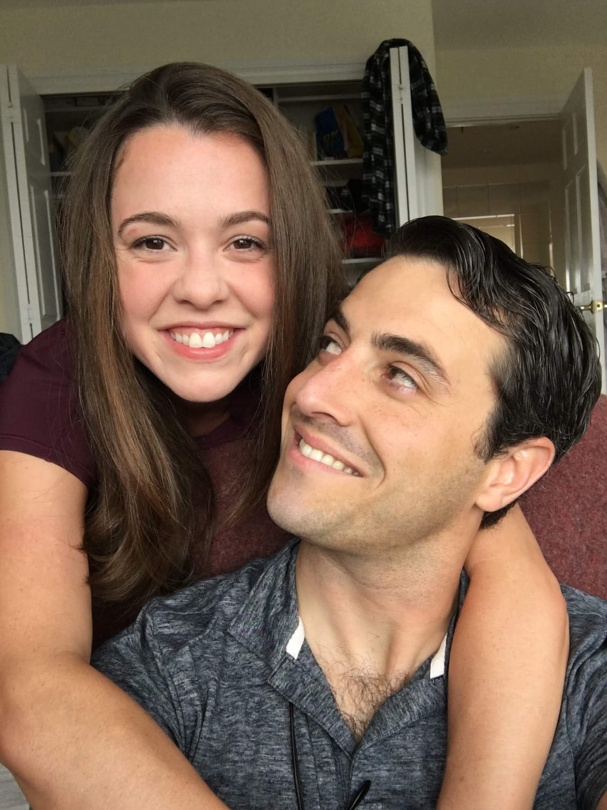 Megan and James, cheek to cheek, smiling into the camera